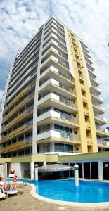 a large building with a swimming pool in front of it at Bonita Hotel in Golden Sands