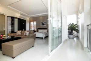 a living room with a couch and a bed at HalongSeoul Hotel in Ha Long