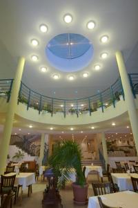 a dining room with tables and a blue ceiling at Bonita Hotel in Golden Sands +20 photos
