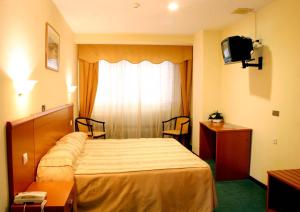 Postel nebo postele na pokoji v ubytování Hotel Las Viñas
