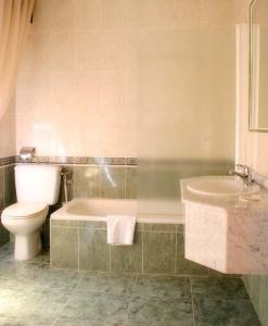 uma casa de banho com uma banheira, um WC e um lavatório. em Hotel Las Viñas em Arteixo