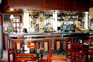 a bar with tables and chairs in a restaurant at Hotel Las Viñas in Arteixo