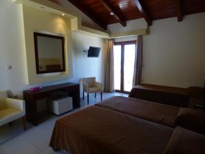 Ένα ή περισσότερα κρεβάτια σε δωμάτιο στο Lemnos Village Resort Hotel