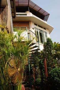 a house with a staircase in front of it at Arun Residence in Bangkok