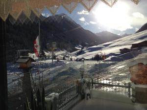 a view of a snow covered mountain with a fence at Gasthof Talblick in Ischgl