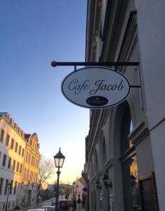 una señal para un lagarto café en el lado de un edificio en Ferienwohnungen auf der Insel am Cafe Jacob, en Werder