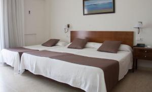 Postel nebo postele na pokoji v ubytování Hotel Sicania