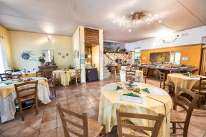 a restaurant with tables and chairs in a room at Agriturismo Costadoro in Bardolino