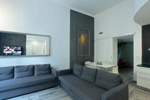a living room with a couch and a table at Apartment House - The Modern Flat in Prague
