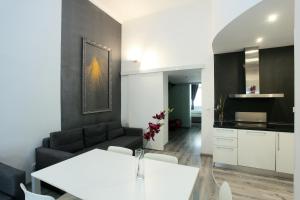 a living room with a couch and a table at Apartment House - The Modern Flat in Prague