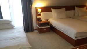 Postel nebo postele na pokoji v ubytování Hotel Porto In