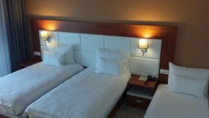 Postel nebo postele na pokoji v ubytování Hotel Porto In