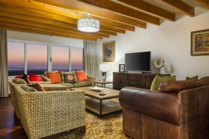a living room with two couches and a flat screen tv at Mohlenweg.14 Self Catering Beach House Swakopmund in Swakopmund