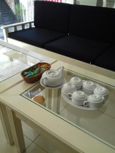 a glass table with a tea set on top of it at SeaSala Hotel in Vung Tau