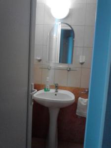 a bathroom with a sink and a mirror at Horváthkert Panzió és Étterem in Bogács