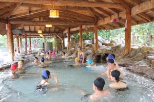 a group of people in the water in a swimming pool at Pei Kong Creek Resort in Guoxing