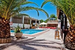 a resort with a pool and palm trees at Hotel Balcón de Cazorla in Cazorla