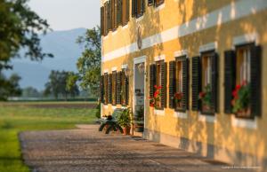 a building with windows and a bench next to a field at Weslhof in Attersee am Attersee