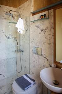 a bathroom with a shower and a toilet and a sink at La Casa Piccola in Chania +60 photos