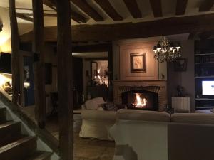 a living room with a couch and a fireplace at B&B les Agapanthes in Gasny