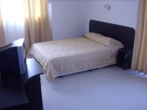 Postel nebo postele na pokoji v ubytování Hotel Paradise