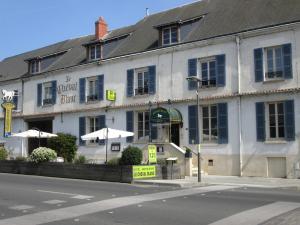 a white building on the corner of a street at Logis Hostellerie Du Cheval Blanc in Sainte-Maure-de-Touraine