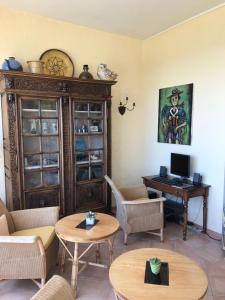 a living room with a computer and a desk at Grand Hotel Moriaz in Le Lavandou