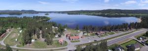 an aerial view of a large lake with a house at Ljusdals Camping in Ljusdal