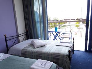 Postel nebo postele na pokoji v ubytování Hotel Dimitra