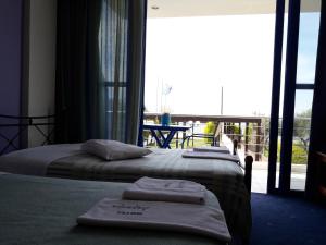 Postel nebo postele na pokoji v ubytování Hotel Dimitra