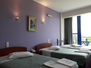 Postel nebo postele na pokoji v ubytování Hotel Dimitra