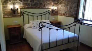 a bedroom with a bed and a stone wall at Casa Leny in La Vega +20 photos