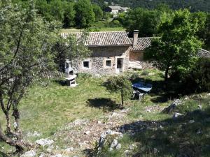 an old stone house in the middle of a field at Gîtes La ferme accrochée à la colline in Lagorce +8 photos