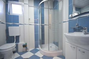 a bathroom with a shower and a toilet and a sink at D&D Apartments 3 in Budva