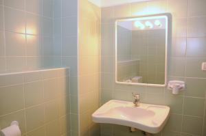 a bathroom with a sink and a mirror at Hotel Oasi in Muggia +30 photos