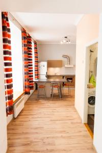 a kitchen with a table and chairs in a room at Rataskaevu Guest Apartment in Tallinn