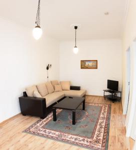 a living room with a couch and a table at Rataskaevu Guest Apartment in Tallinn