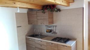 a kitchen with a sink and a stove at Casa a picco sul mare 5 terre in Campiglia