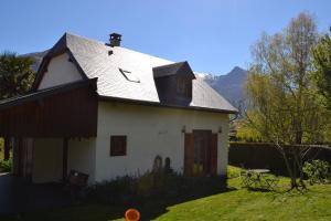 a white house with a gambrel roof at Enço deth terralh in Pierrefitte-Nestalas