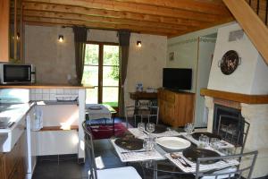 a kitchen with a table with wine glasses on it at Enço deth terralh in Pierrefitte-Nestalas