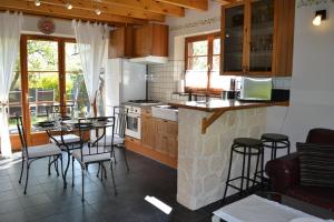 a kitchen with a counter and a table and chairs at Enço deth terralh in Pierrefitte-Nestalas