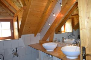 two sinks in a bathroom with wooden ceilings at Enço deth terralh in Pierrefitte-Nestalas +4 photos