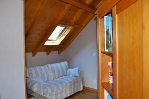 a living room with a couch and a window at Enço deth terralh in Pierrefitte-Nestalas