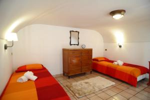 a bedroom with two twin beds and a dresser at Daniela House in Maiori +24 photos