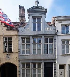 a building with a flag in front of it at Braamberg B&B in Bruges