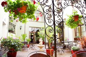 a courtyard with a bunch of potted plants at Old Riga Boutique Hotel "Vecriga" in Riga