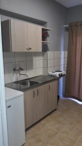 a kitchen with a sink and a counter top at Villa Elena in Olympic Beach