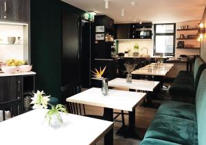 a restaurant with white tables and green walls at Linden Hotel in Amsterdam