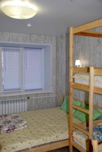 a bedroom with a bed and a window at Hostel Gurtyeva in Oryol
