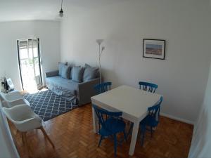 uma sala de estar com uma mesa e cadeiras e um sofá em Olival 178 em Lisboa